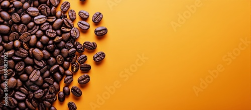 Dark Roasted Coffee Beans Scattered on an Orange Surface Offering Ample Space