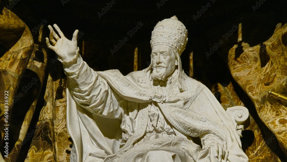 Obraz premium Rome, Italy - 10 January 2025. Marble statue of Gregory XV in ceremonial robes with a raised hand, set against detailed stonework inside Chiesa di Sant’Ignazio.