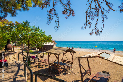 Fototapeta Naklejka Na Ścianę i Meble -  Beach with Picnic Tables and Ocean View