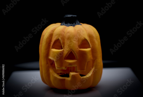 Illuminated Halloween pumpkin on a black background with space for advertising. Ideal for Halloween on October 31st.