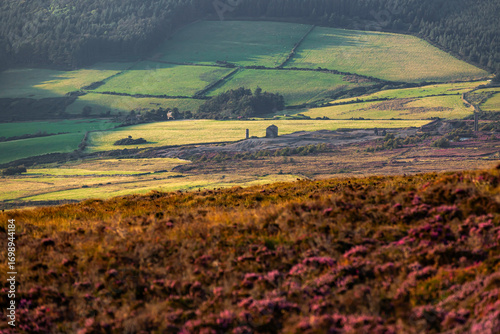 Douglas, Isle of Man 08,05,2023 Field of grass with a small building in the distance. The sky is clear and the sun is shining brightly Isle of Man -