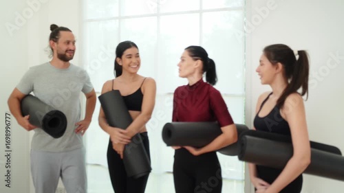 A group engages in a yoga session in a tranquil studio, focusing on relaxation and mindfulness. Participants share positive energy and laughter, enhancing their community bond.
