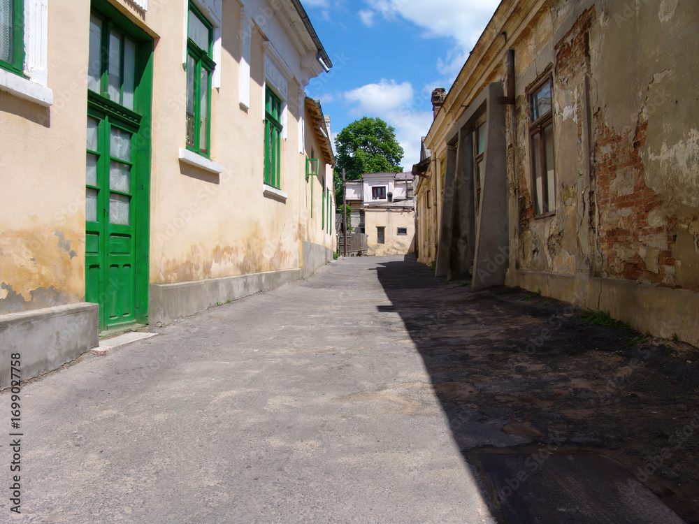 Fototapeta premium historic buildings on a street in the old town in Galati Romania build before the world war , back alley daytime in the city center
