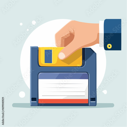 Hand Inserting Yellow Floppy Disk Into Blue Disk Drive