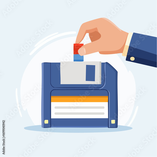 Hand Inserting Red Tab Into Blue Floppy Disk