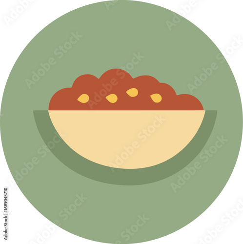Close-up of a creamy dish with reddish-brown garnishes in a tilted bowl on a light green background