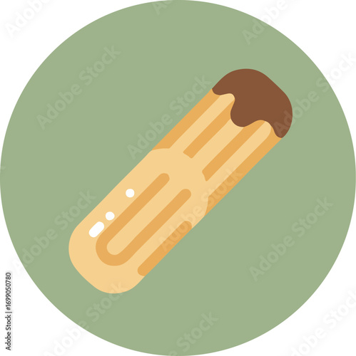 Close-up of an elongated pastry with dark chocolate coating on a green background