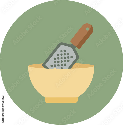 Yellow ceramic bowl with silver cheese grater on green background