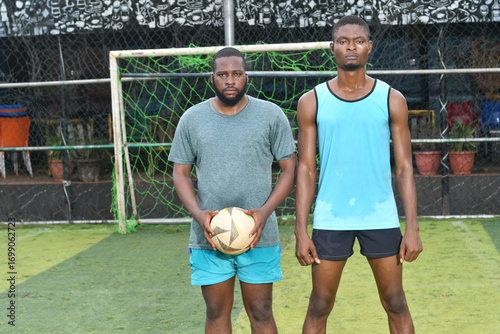 two african Soccer players having fun after friendly match on soccer field