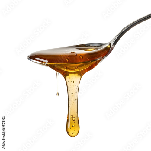 Honey dripping from spoon isolated on white background