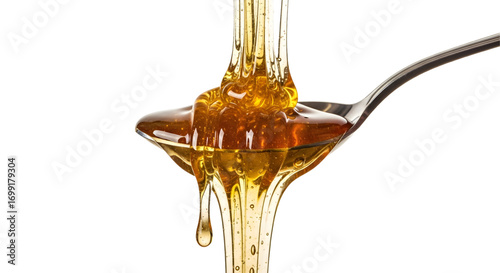 Honey dripping from spoon isolated on white background
