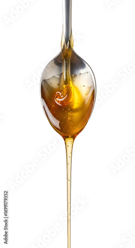 Honey dripping from spoon isolated on white background