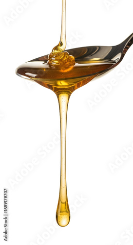 Honey dripping from spoon isolated on white background