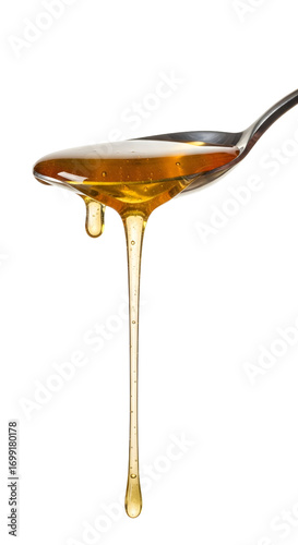 Honey dripping from spoon isolated on white background