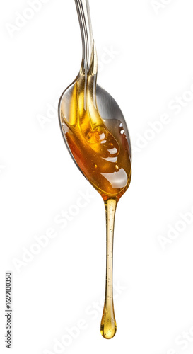 Honey dripping from spoon isolated on white background
