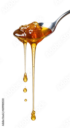 Honey dripping from spoon isolated on white background