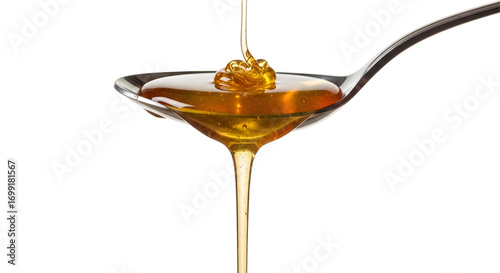 Honey dripping from spoon isolated on white background