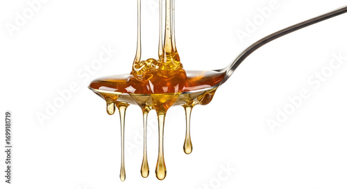 Honey dripping from spoon isolated on white background