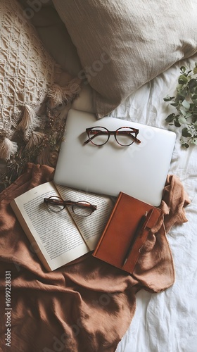 Wallpaper Mural Aesthetic flat lay of a laptop open book brown notebook and tortoiseshell glasses arranged on a rumpled terracotta cloth. Torontodigital.ca