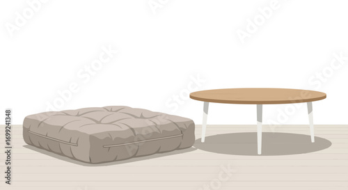 Simple interior scene featuring a floor cushion and a round wood table