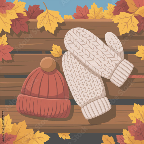 Warm Knitted Hat and Mittens on Wooden Surface with Autumn Leaves for Cozy Season