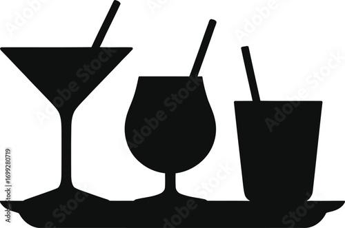 Silhouette of three different cocktail glasses with straws on a tray