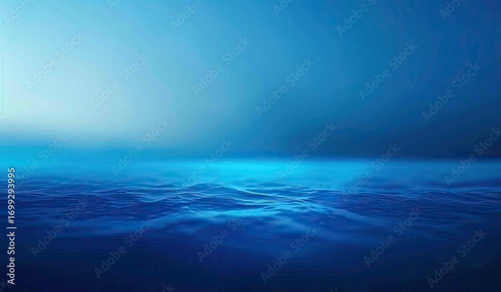 Obraz premium Serene ocean scene at dawn or dusk, featuring a gradient of deep blues, from a lighter sky to darker water with subtle wave textures