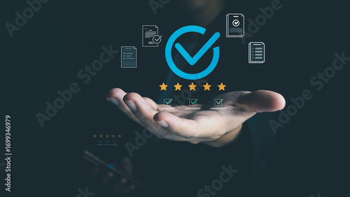 A businessman's hand holds digital icons for quality assurance, including a checkmark, stars, and documents, symbolizing high standards and customer satisfaction in a business process.