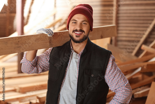 Young carpenter with wooden...