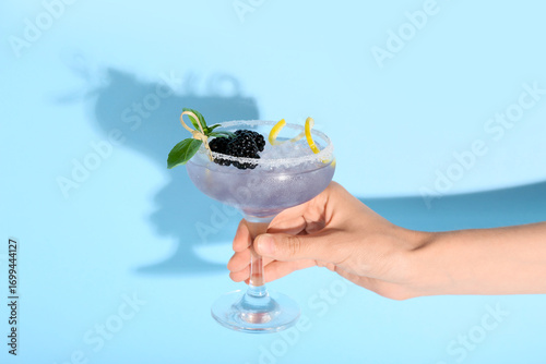 Female hand holding glass w...