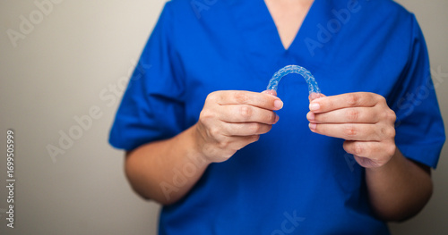 Dentist holding clear aligner orthodontic splint - Dental care and teeth correction treatment