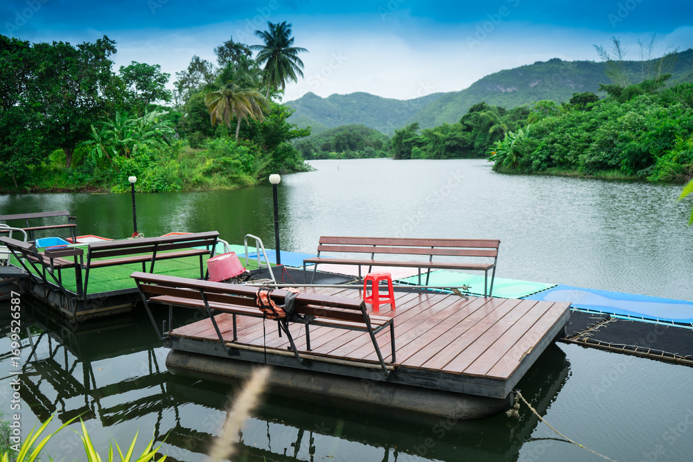 Obraz premium Floating terrace on the river that for outdoor meeting or party to close the nature with lake, forest and mountain at Thailand.