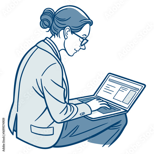 Professional woman wearing glasses and a suit jacket working on a laptop computer with her hair in a bun