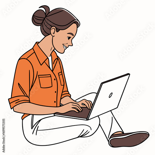 Smiling woman with hair in a bun wearing an orange shirt and white pants using a laptop while sitting on the floor