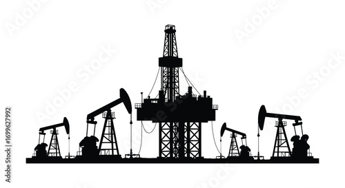 oil rigs and pumps silhouette against clear sky