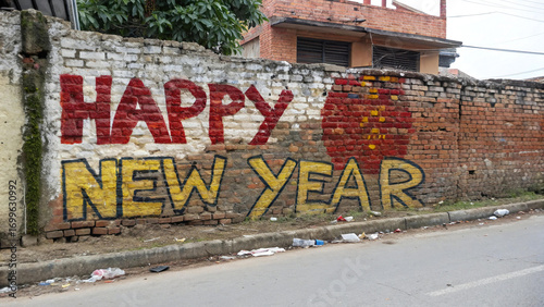 Weathered brick wall showing happy new year message styled in artistic vintage design
