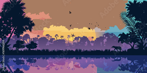 Silhouette of an elephant walking by a jungle lake at sunset