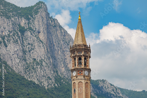 Bell tower of basilica of Saint Nicholas (Campanile di San Nicolo) dominating the view in Lecco, Italy. St. Nicholas is Lecco's patron saint.