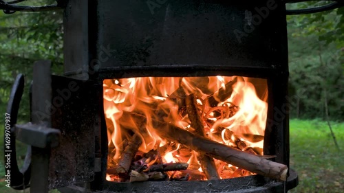 Fire place with red flame and pine cones. 4K video footage