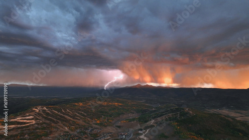 Beautiful drone sunset storm lightning view over mountains at in Colorado fall