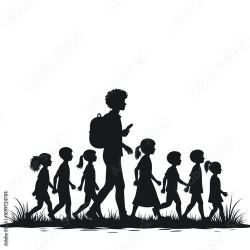 Silhouette of adult with backpack leading group of children walking