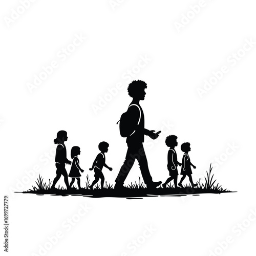 Silhouette of man with backpack and children walking in grass