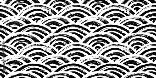 Abstract black and white seamless pattern of hand painted wavy brush strokes forming scales or waves