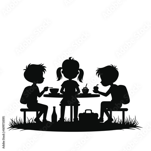 Three children eating lunch at a picnic table silhouette