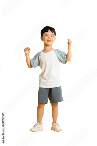 Obraz na plátně Asian kid A cheerful young boy stands, raising his arms in glee