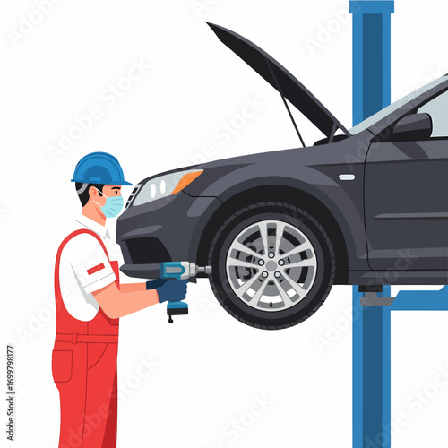 A mechanic in red overalls and a face mask works on a car lifted on a hydraulic car lift, using a power drill.