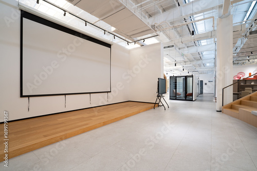 Fototapeta Naklejka Na Ścianę i Meble -  Modern office space with projection screen and tiered seating