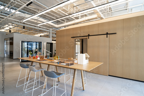 Quadro su tela Modern office space with a long table, stools and glass partitions