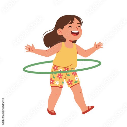  a child wearing a yellow tank top and floral-patterned shorts, laughing as she successfully spins a green hula hoop around her waist