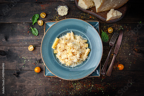 Fusilli quattro formaggi pasta served on a plate. Spiral pasta in creamy cheese sauce with rich Italian flavor and gourmet style.